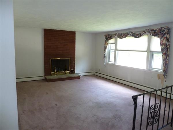 20 Fenwick Road Chelmsford, MA 01824 - Photo 3 of 15 a view of an empty room with a fireplace and a window