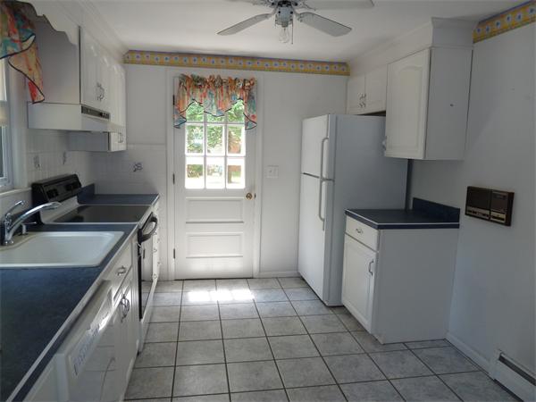 20 Fenwick Road Chelmsford, MA 01824 - Photo 5 of 15 a kitchen with a stove a sink and a refrigerator