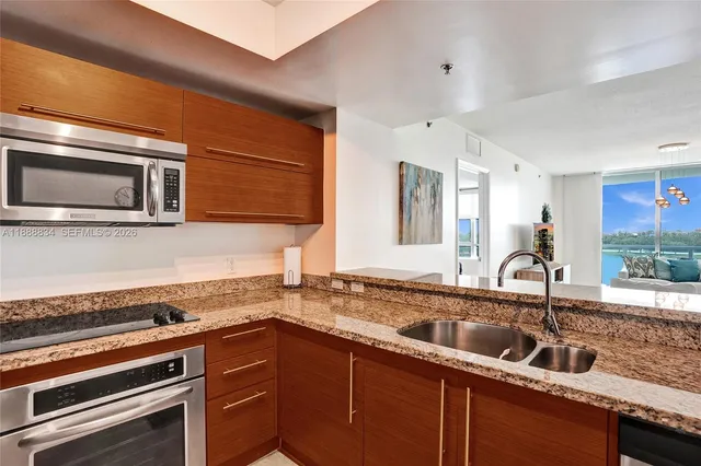 a kitchen with granite countertop a sink and cabinets