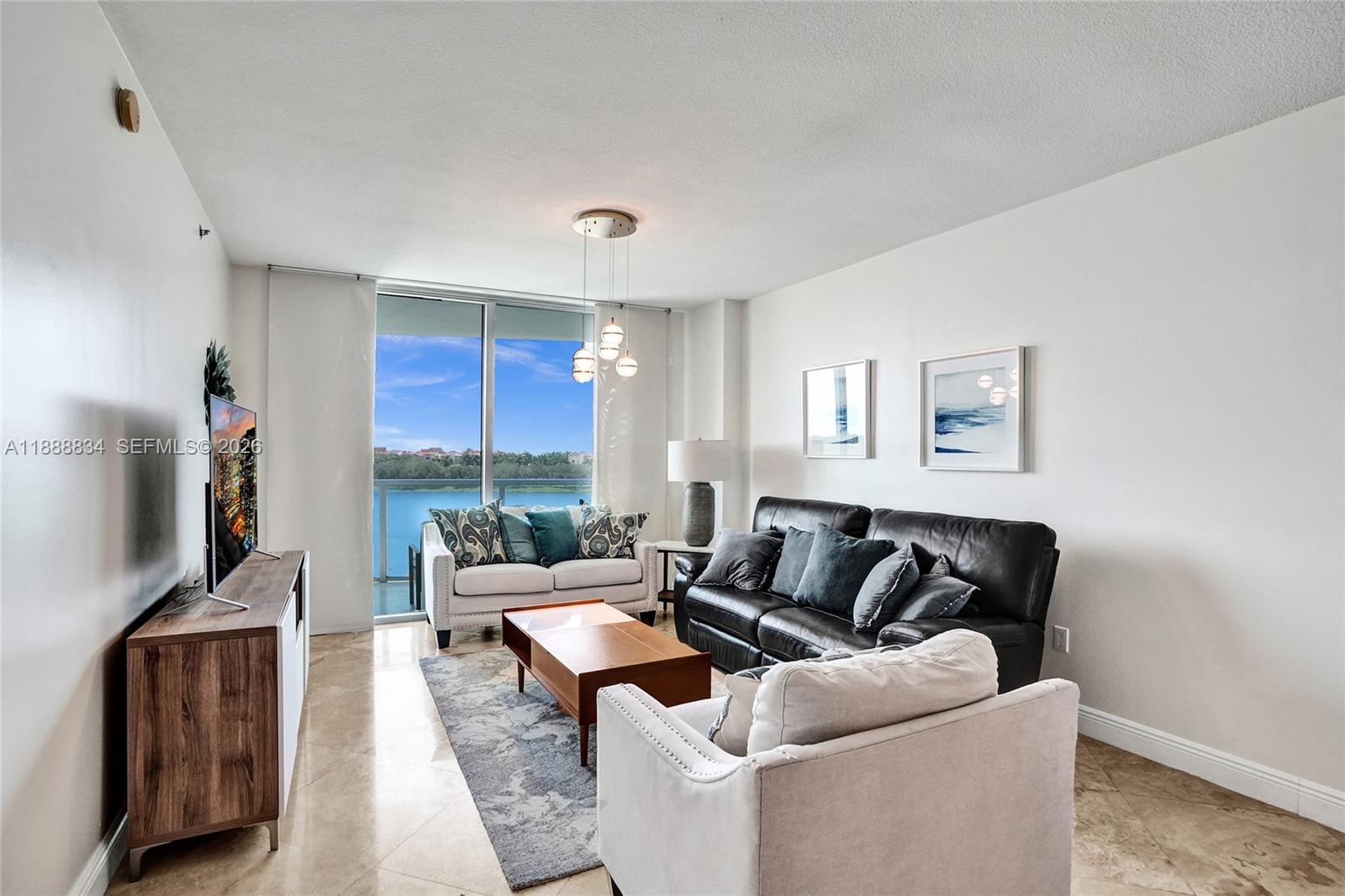 2681 North Flamingo Road, Unit 605S Sunrise, FL 33323 - Photo 15 of 47 a living room with furniture and a flat screen tv