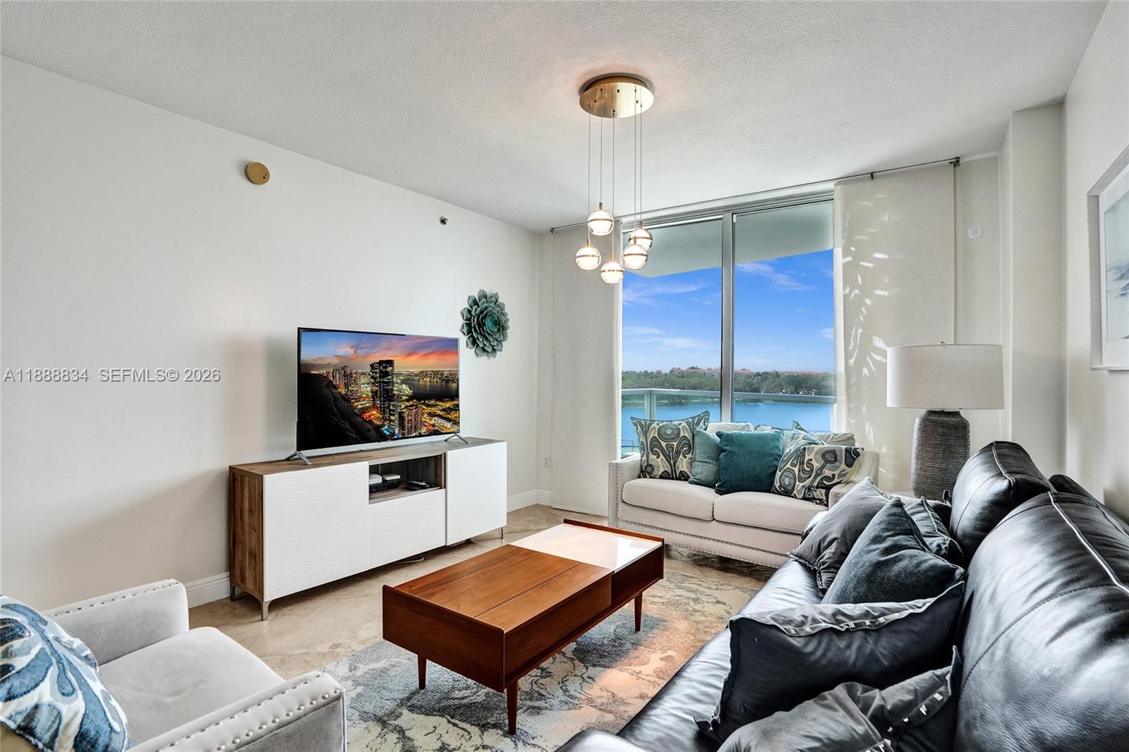 2681 North Flamingo Road, Unit 605S Sunrise, FL 33323 - Photo 17 of 47 a living room with furniture and a flat screen tv