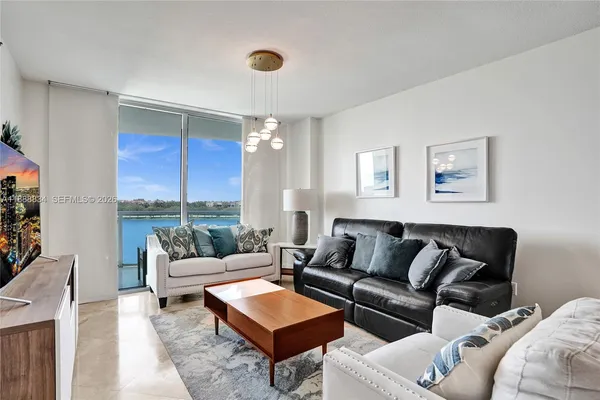 a living room with furniture and a large window