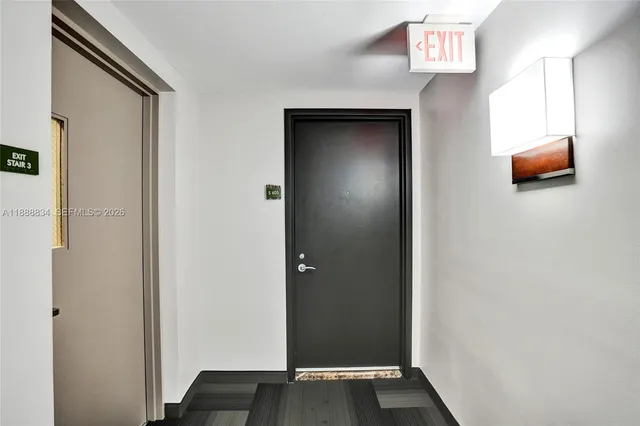 a view of an entryway with wooden floor