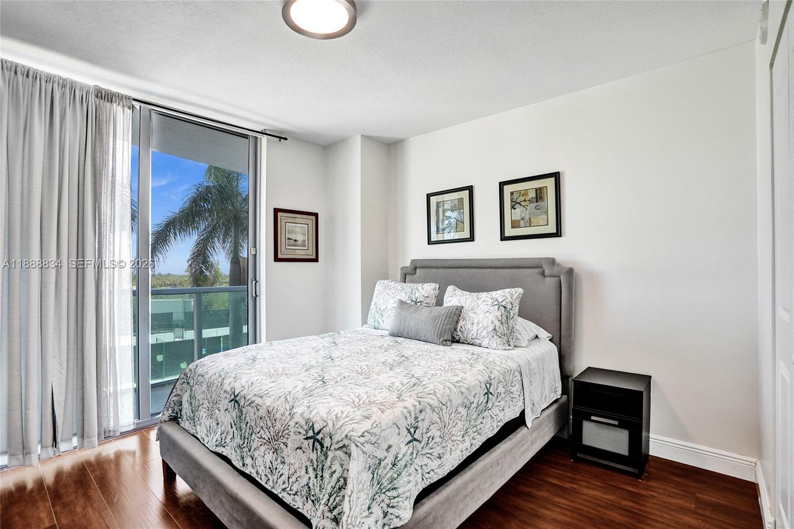 2681 North Flamingo Road, Unit 605S Sunrise, FL 33323 - Photo 36 of 47 a bedroom with a bed and a painting on the wall