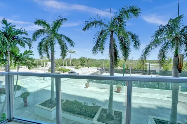 a view of a palm plant from a balcony