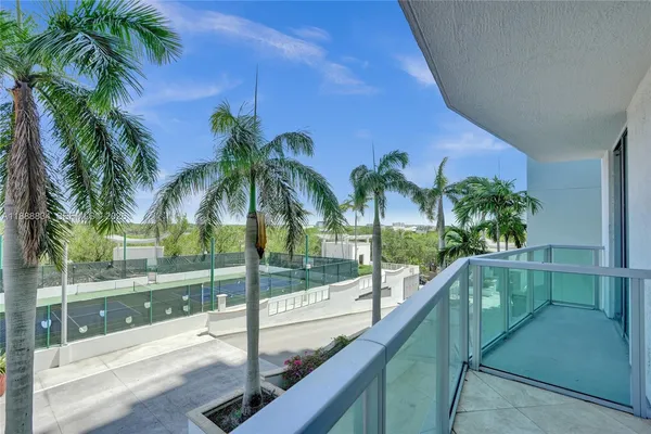a view of swimming pool with a patio and palm tree