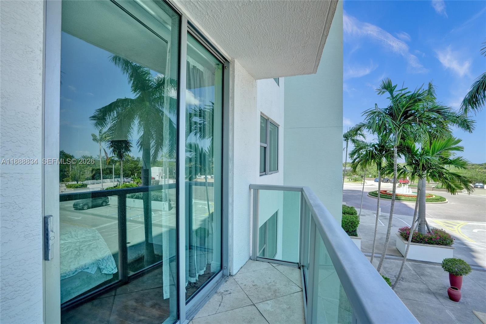 2681 North Flamingo Road, Unit 605S Sunrise, FL 33323 - Photo 45 of 47 a porch with a table and chairs next to a yard