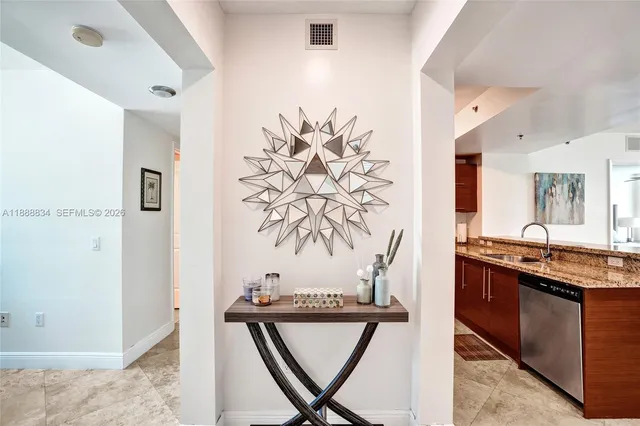 a view of kitchen with stainless steel appliances granite countertop a stove a sink and a refrigerator
