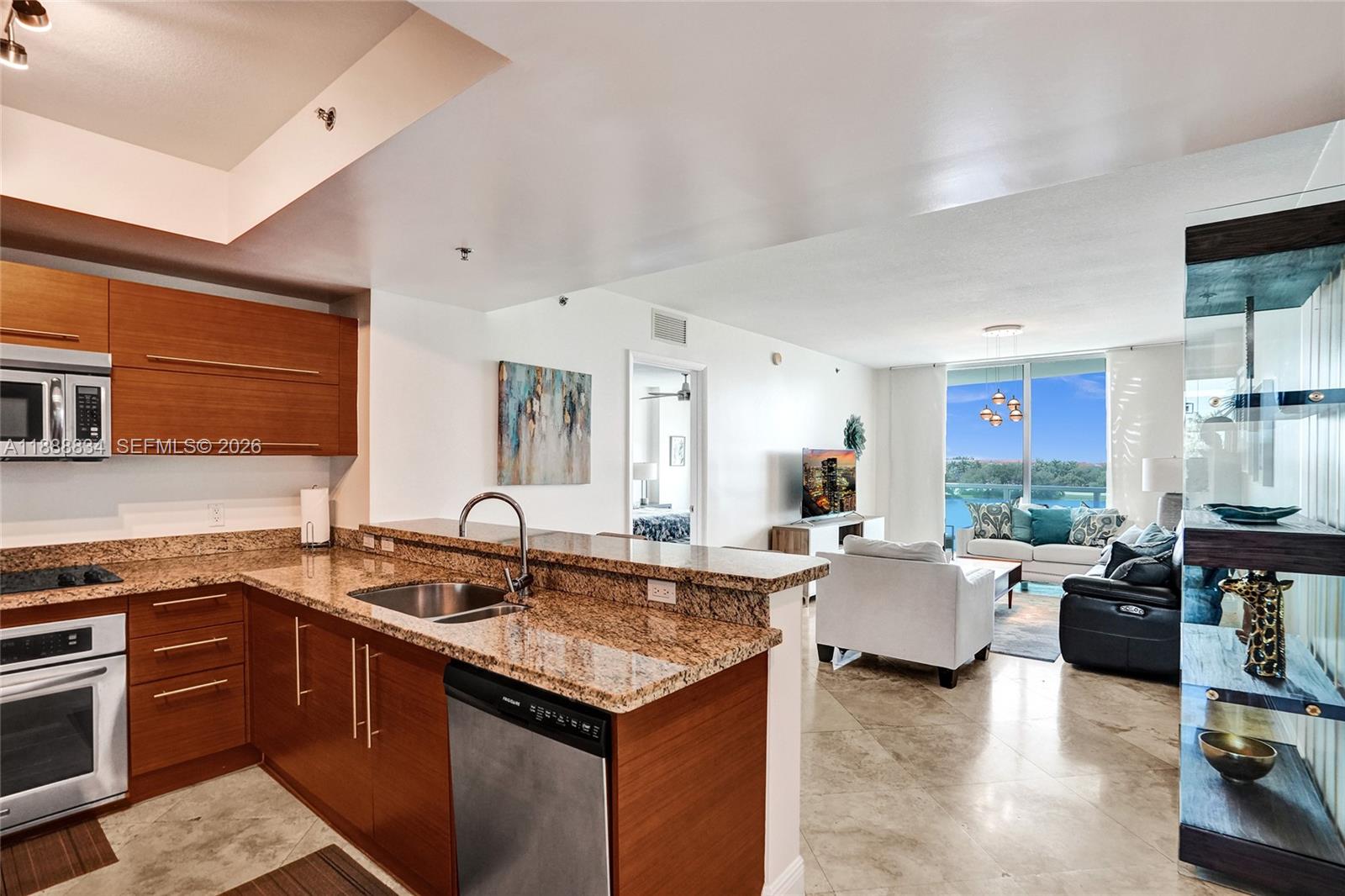 2681 North Flamingo Road, Unit 605S Sunrise, FL 33323 - Photo 7 of 47 a open kitchen with stainless steel appliances granite countertop a sink dishwasher and a stove with wooden floor