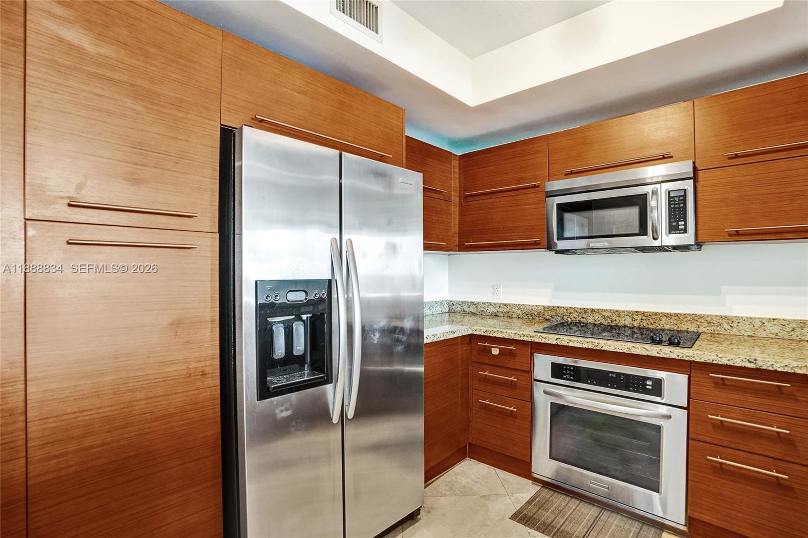 2681 North Flamingo Road, Unit 605S Sunrise, FL 33323 - Photo 8 of 47 a kitchen with stainless steel appliances granite countertop a refrigerator and a stove top oven