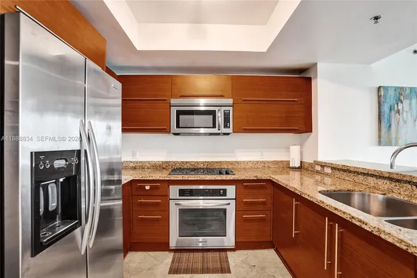 a kitchen with a sink stove and refrigerator
