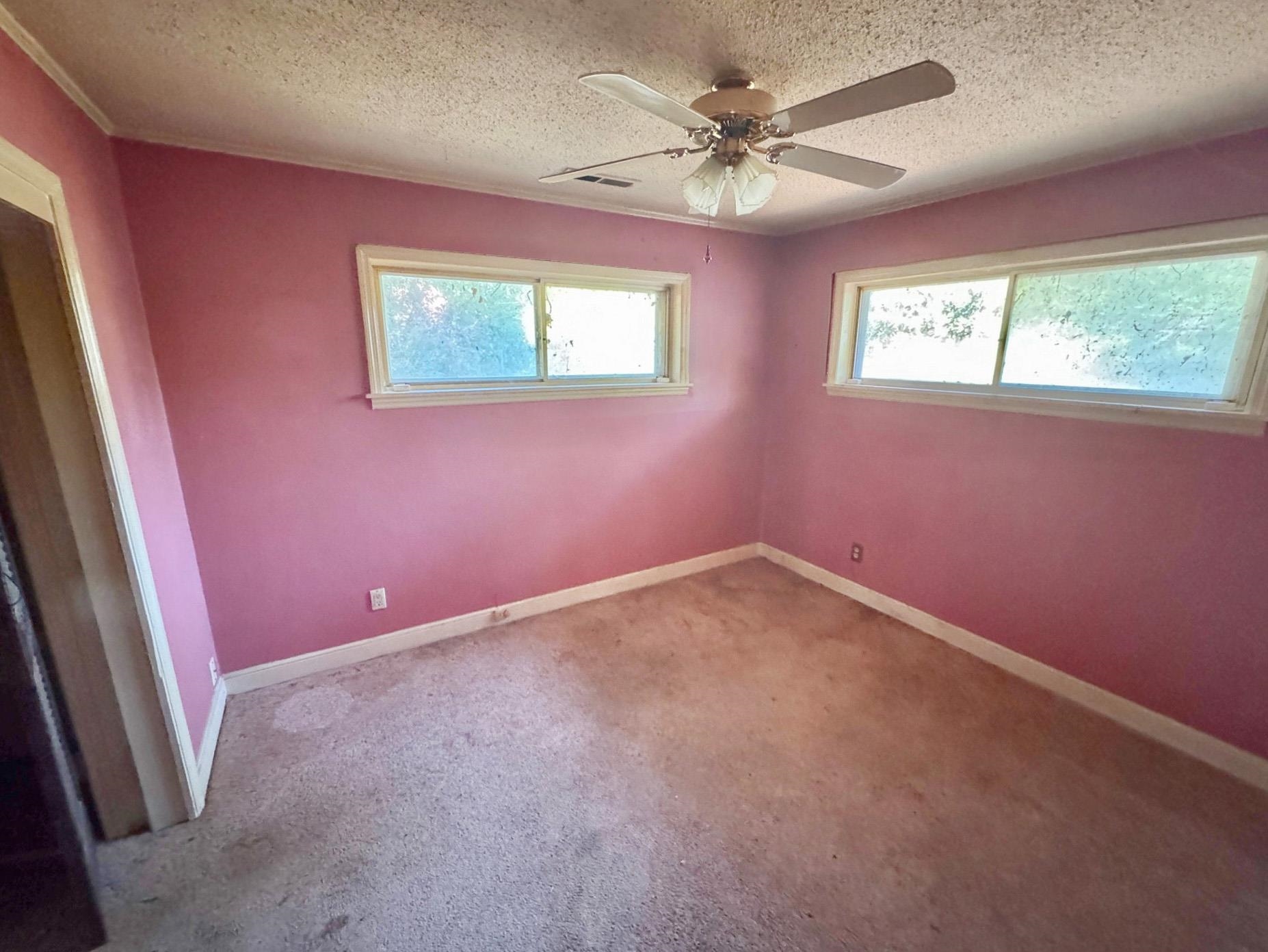 6014 Raleigh Lagrange Road Memphis, TN 38134 - Photo 11 of 19 Spare room with a textured ceiling, carpet floors, and a ceiling fan