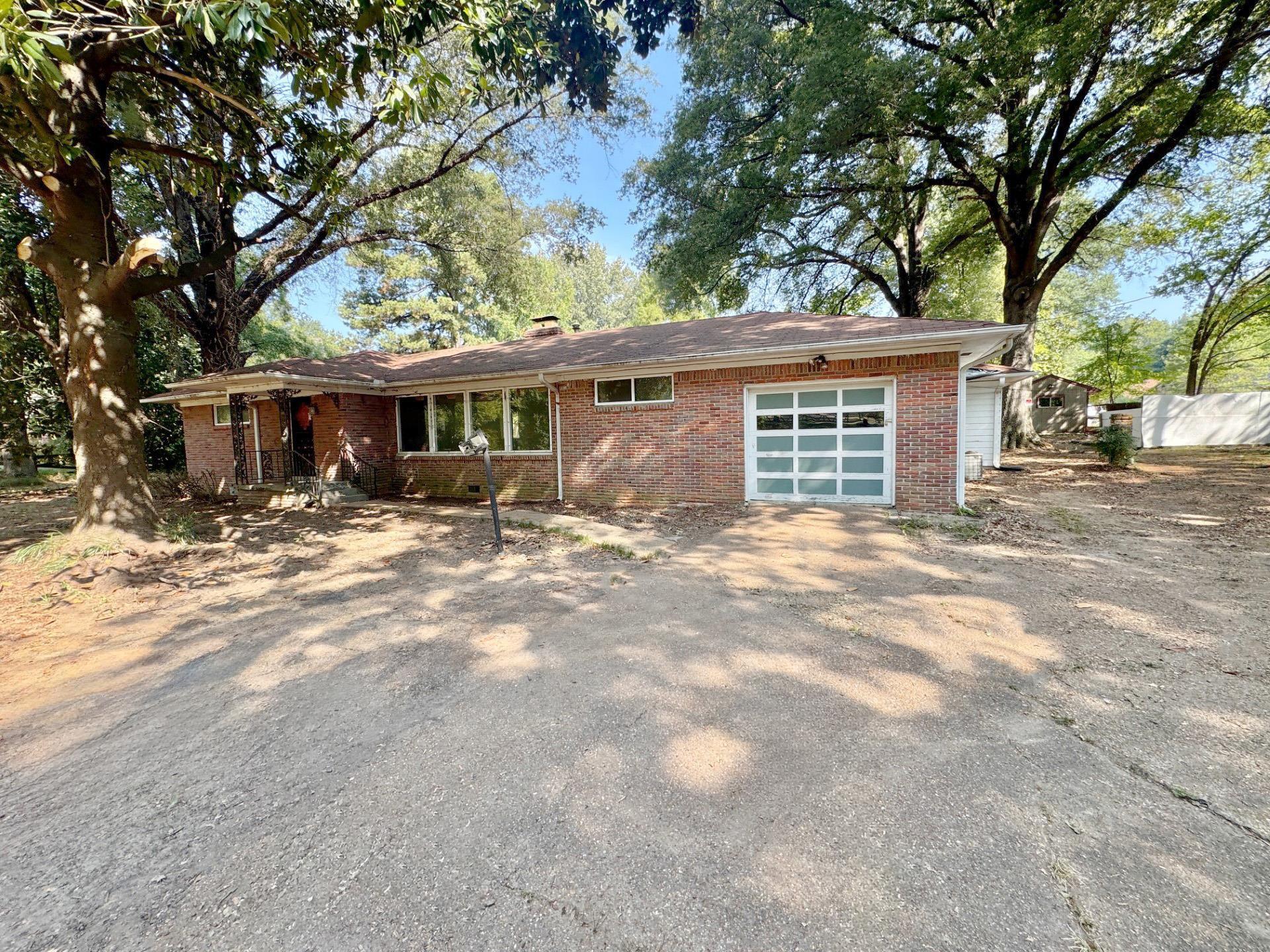 6014 Raleigh Lagrange Road Memphis, TN 38134 - Photo 2 of 19 Ranch-style home with brick siding, an attached garage, a chimney, and driveway