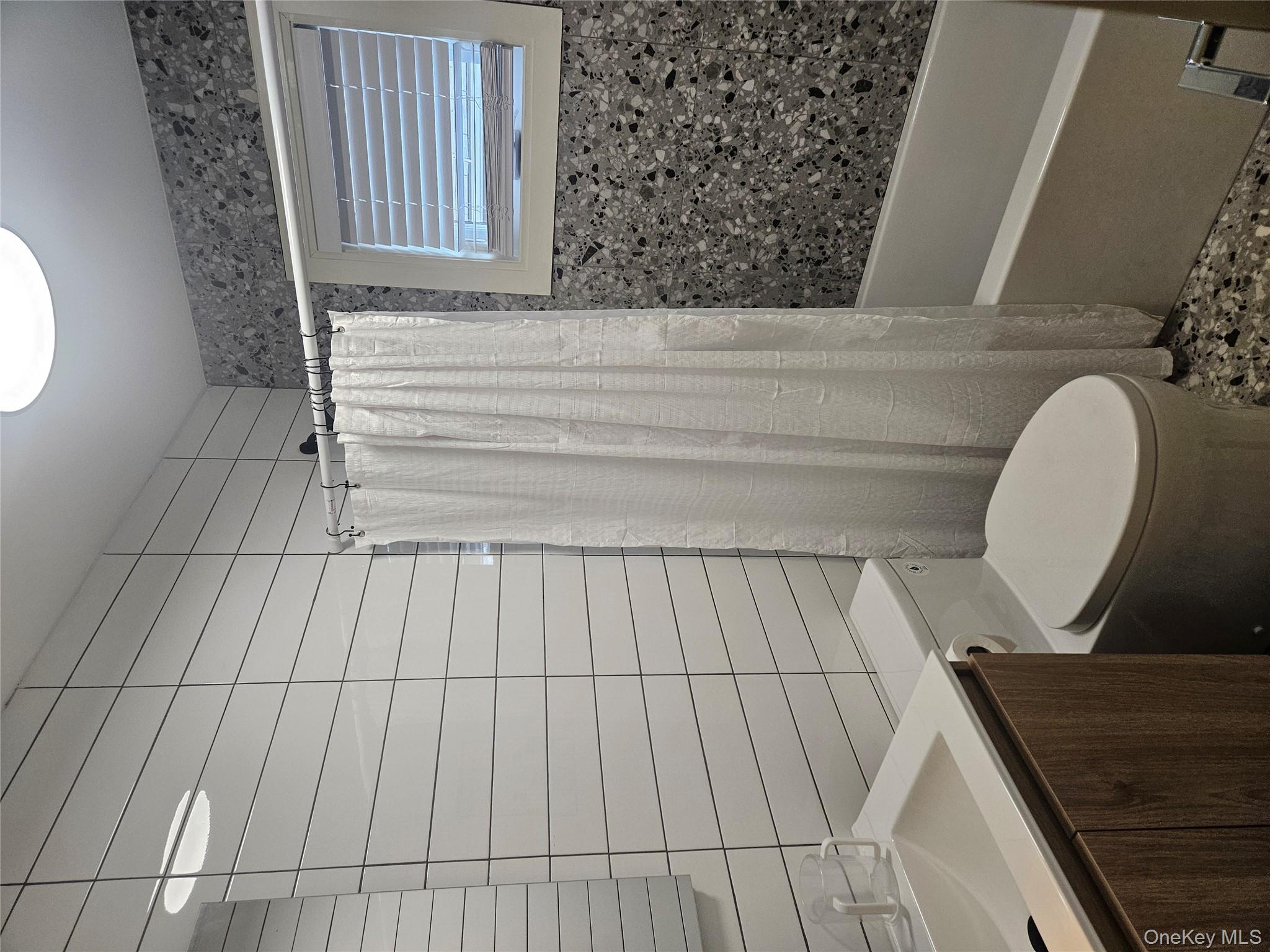 344 Bayview Avenue Inwood, NY 11096 - Photo 11 of 12 a bathroom with a sink a toilet and shower
