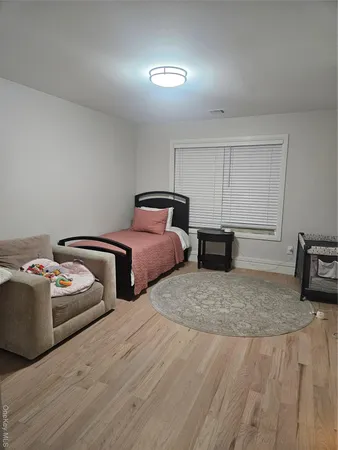 a bedroom with two beds and painting on the wall