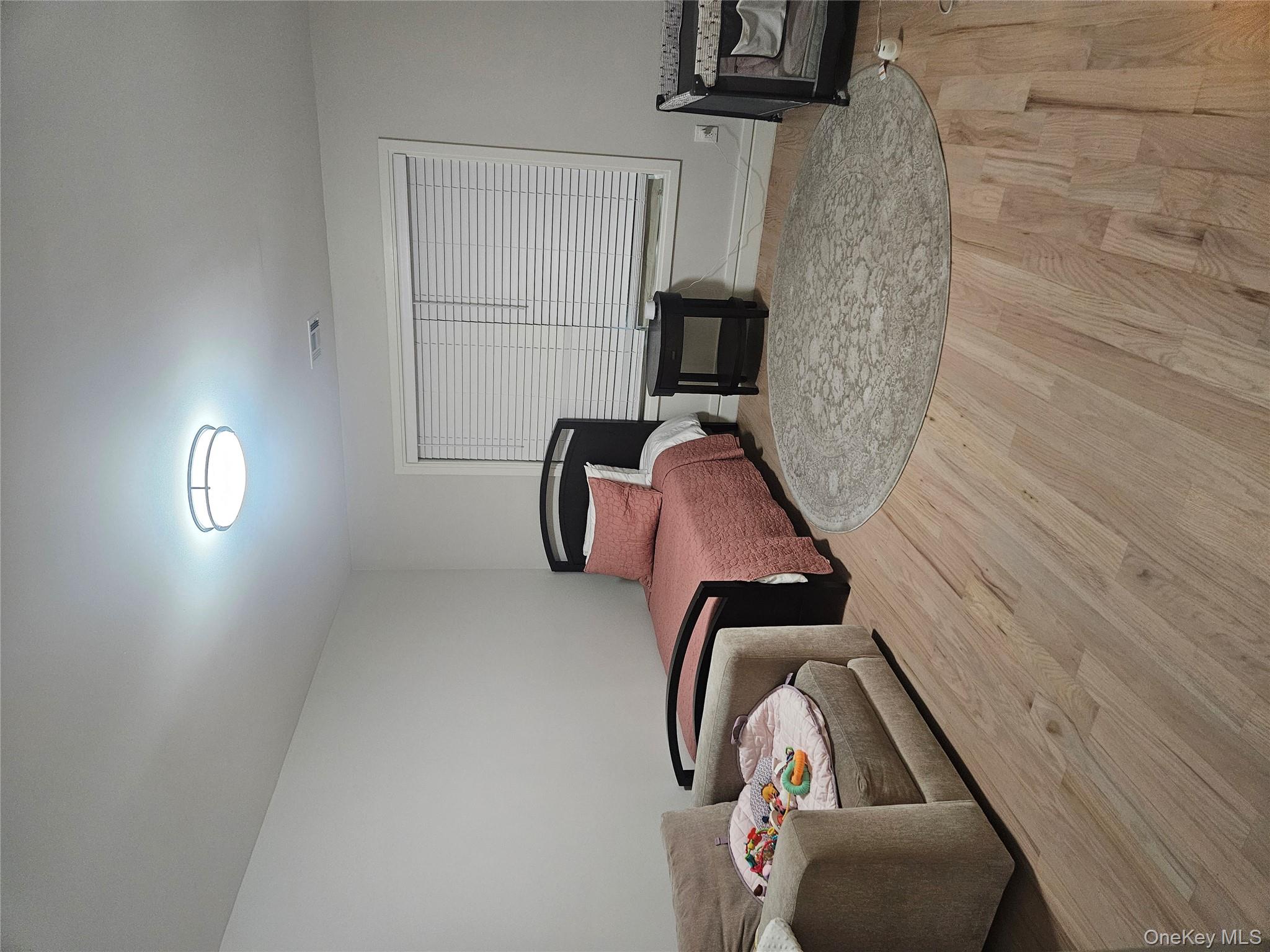 344 Bayview Avenue Inwood, NY 11096 - Photo 12 of 12 a bedroom with two beds and painting on the wall