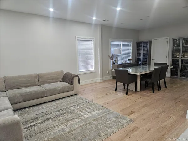 a living room with furniture a dining table and a piano table