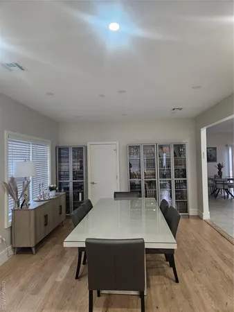 a living room with furniture a dining table and chairs with wooden floor