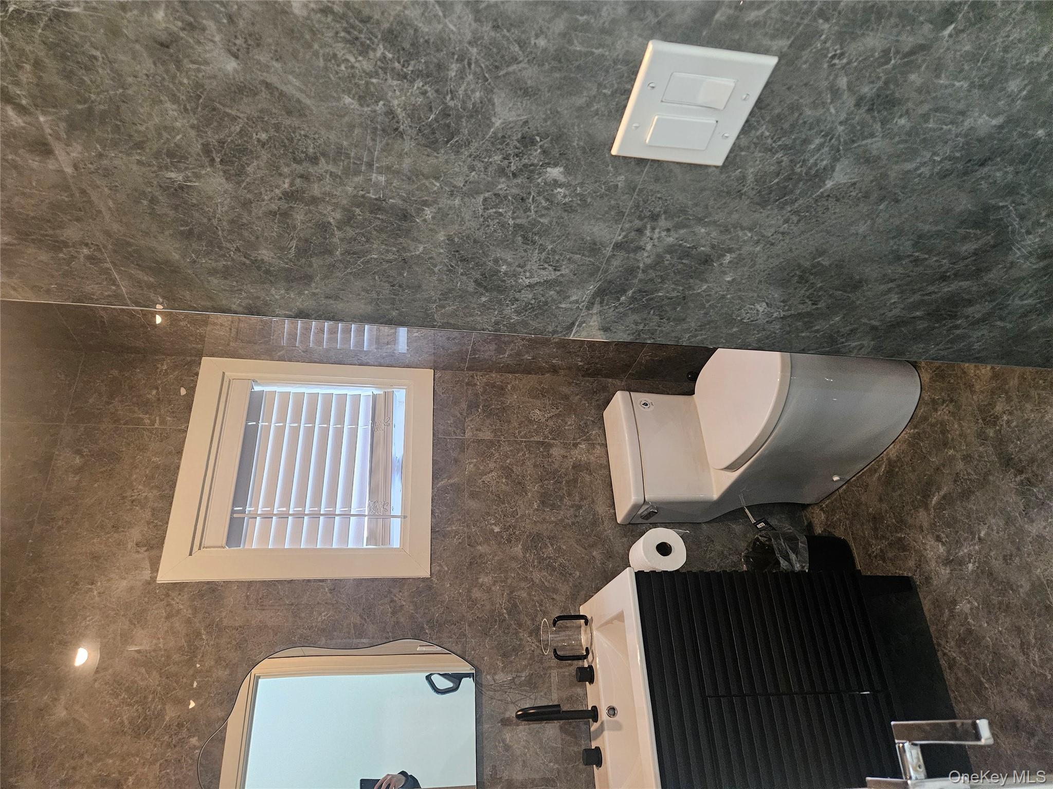 344 Bayview Avenue Inwood, NY 11096 - Photo 6 of 12 a bathroom with a toilet sink and mirror