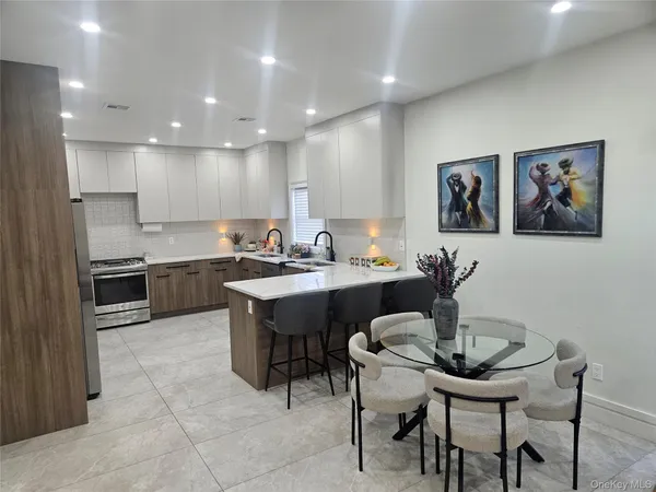 a kitchen with a table chairs sink and cabinets