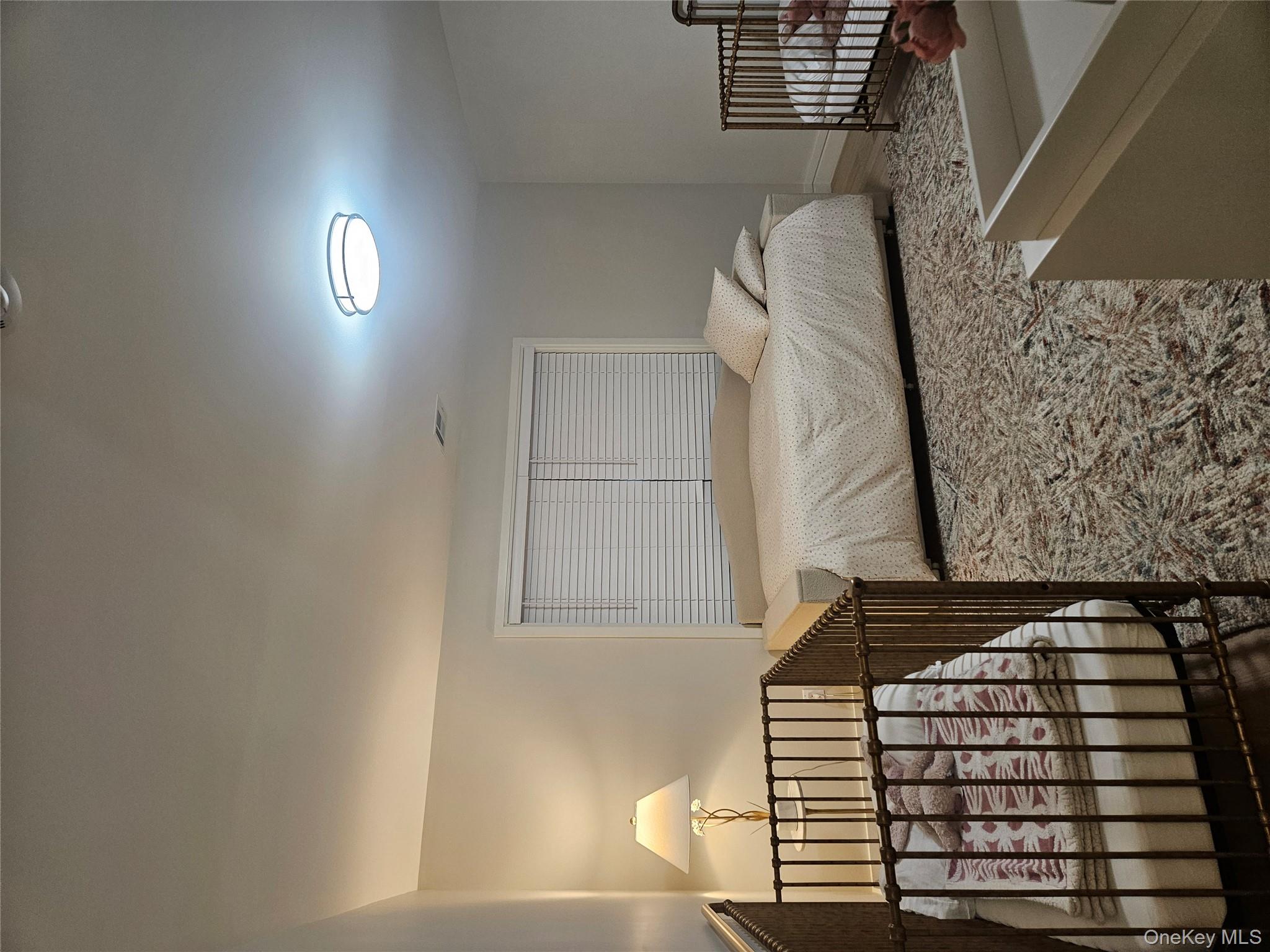 344 Bayview Avenue Inwood, NY 11096 - Photo 9 of 12 a bedroom with a bed and a window