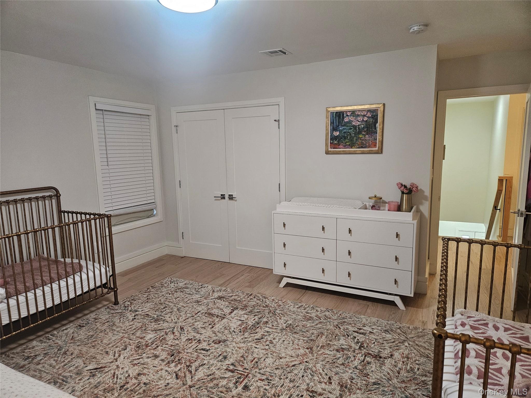 344 Bayview Avenue Inwood, NY 11096 - Photo 10 of 12 a view of a bedroom with furniture and wooden floor