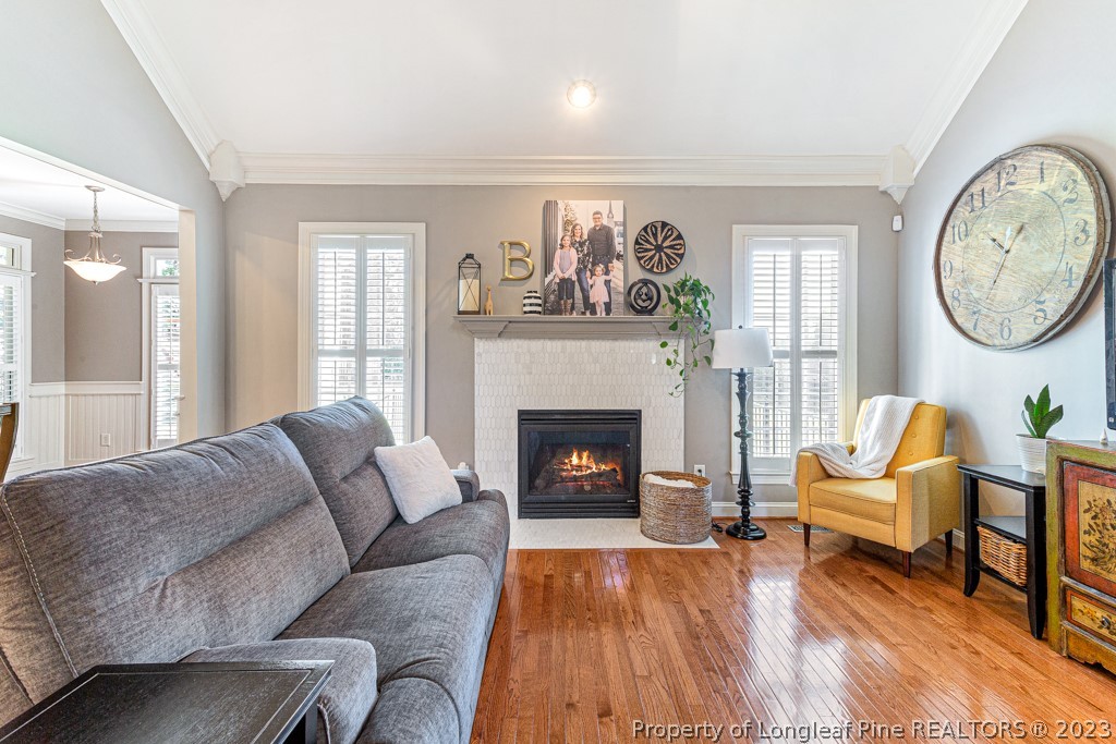 645 Little Bridge Road Fayetteville, NC 28311 - Photo 11 of 49 a living room with furniture a fireplace and a large window