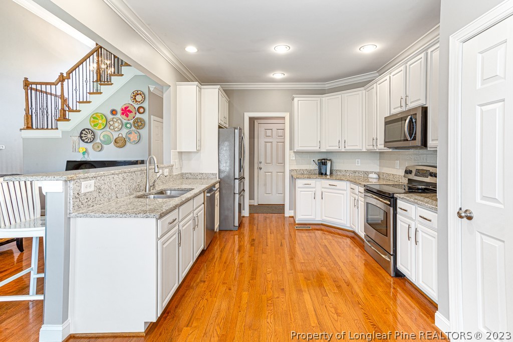 645 Little Bridge Road Fayetteville, NC 28311 - Photo 17 of 49 a large kitchen with stainless steel appliances granite countertop a stove and a sink