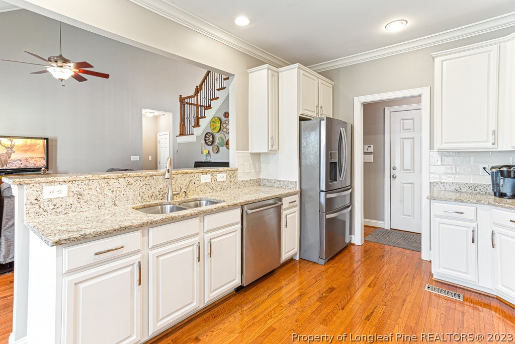 645 Little Bridge Road Fayetteville, NC 28311 - Photo 18 of 49 a kitchen with a sink stove and refrigerator