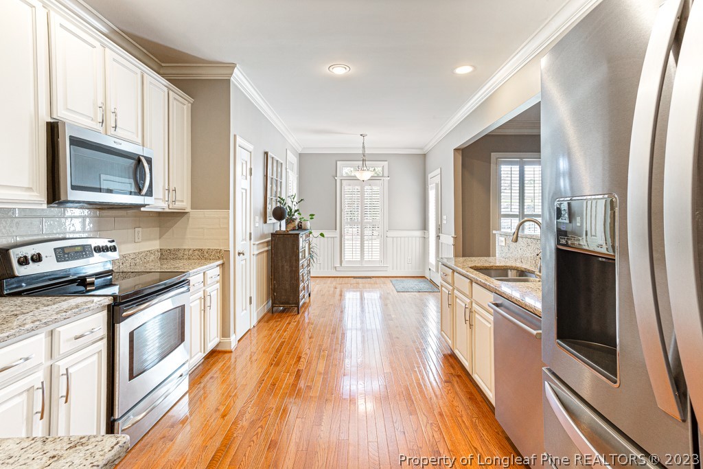 645 Little Bridge Road Fayetteville, NC 28311 - Photo 20 of 49 a kitchen with stainless steel appliances granite countertop a refrigerator a stove top oven and sink