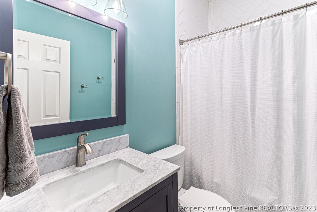 645 Little Bridge Road Fayetteville, NC 28311 - Photo 24 of 49 a bathroom with a granite countertop sink and a mirror