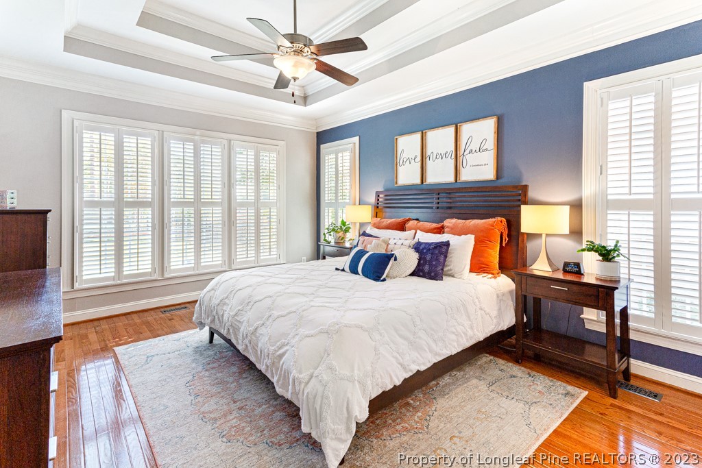 645 Little Bridge Road Fayetteville, NC 28311 - Photo 25 of 49 a bedroom with a large bed and a chandelier