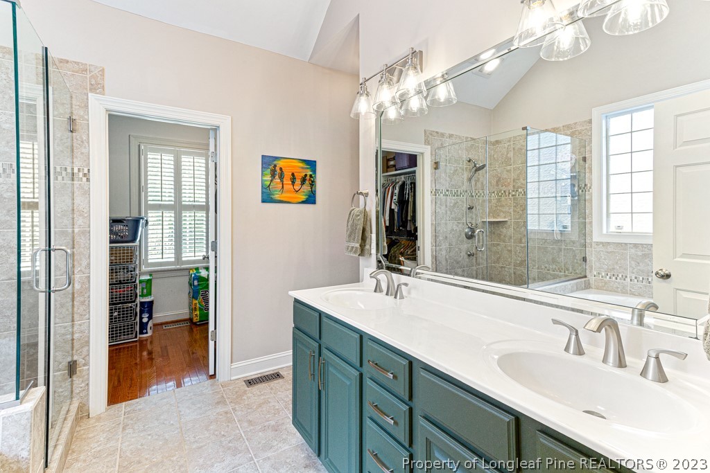 645 Little Bridge Road Fayetteville, NC 28311 - Photo 27 of 49 a bathroom with a sink double vanity granite tub shower and a mirror