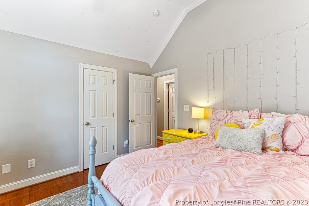 645 Little Bridge Road Fayetteville, NC 28311 - Photo 33 of 49 a bedroom with a bed and a table