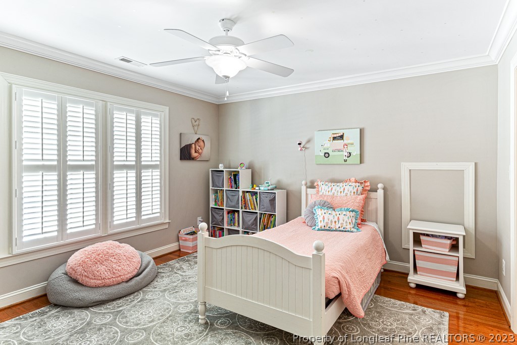645 Little Bridge Road Fayetteville, NC 28311 - Photo 36 of 49 a bedroom with a bed and a chandelier