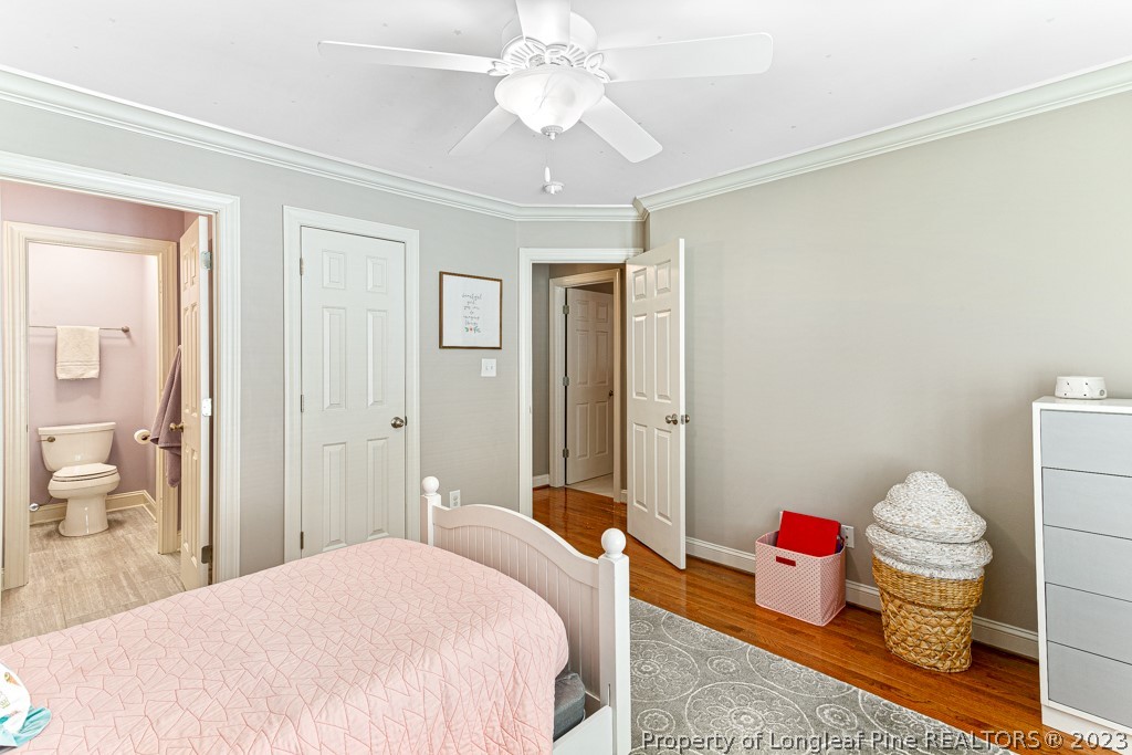 645 Little Bridge Road Fayetteville, NC 28311 - Photo 37 of 49 a bedroom with a bed and a chandelier