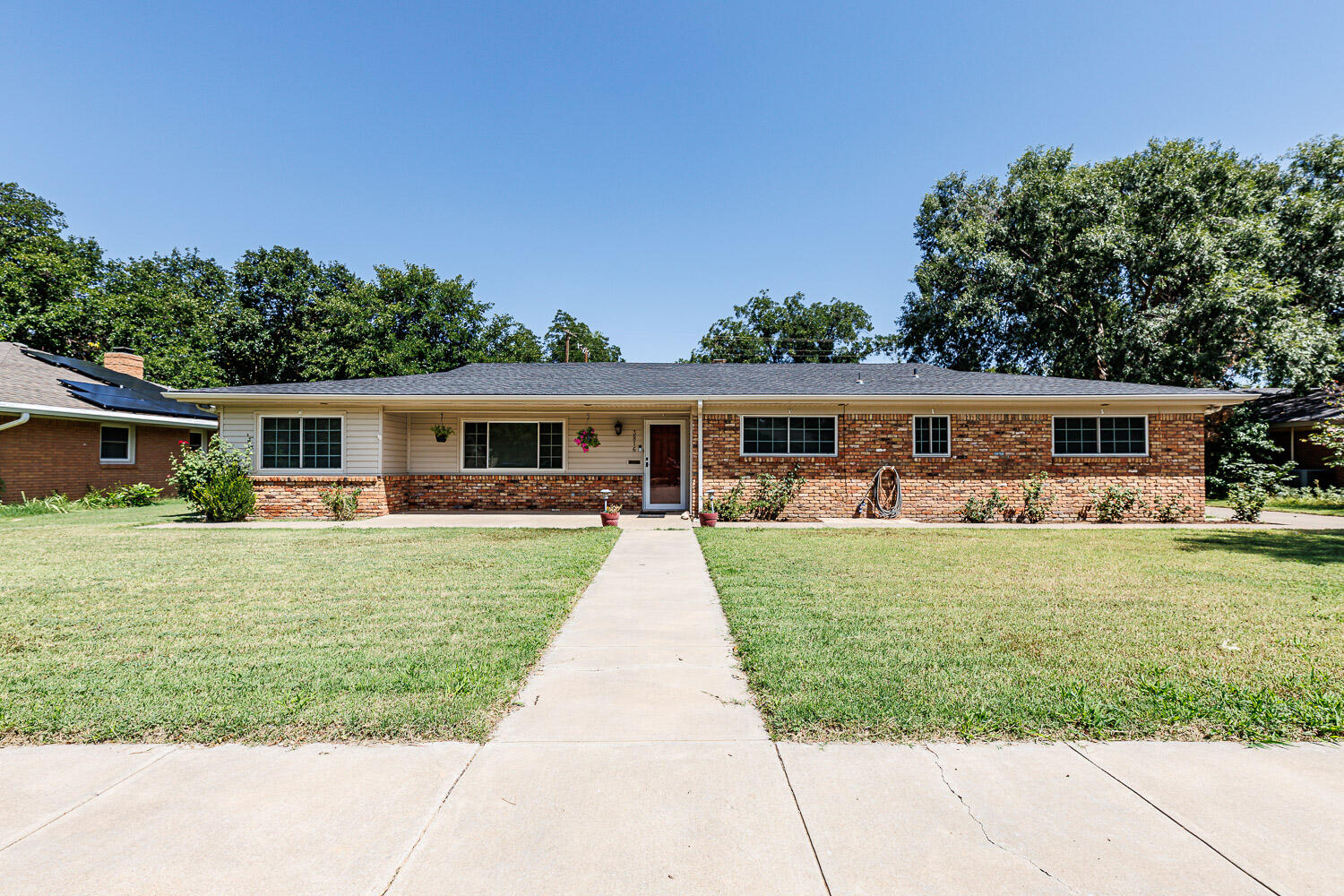 3816 53rd Street Lubbock, TX 79413 - Photo 1 of 59 front view of house with a yard and potted plants
