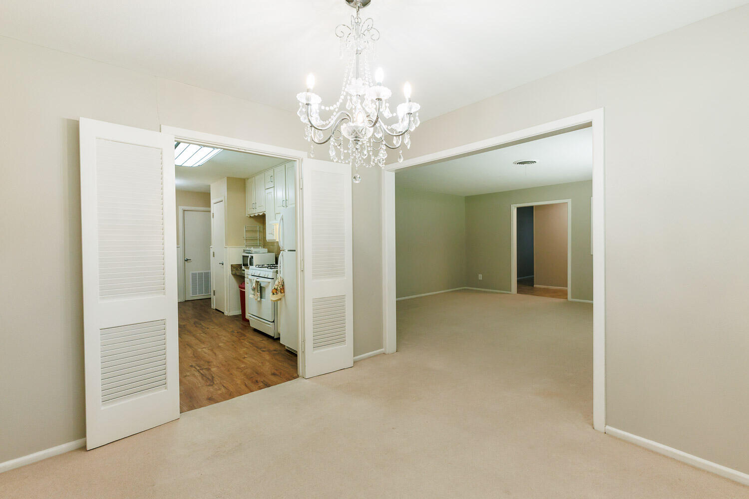 3816 53rd Street Lubbock, TX 79413 - Photo 11 of 59 a view of a hallway with wooden floor and a living room