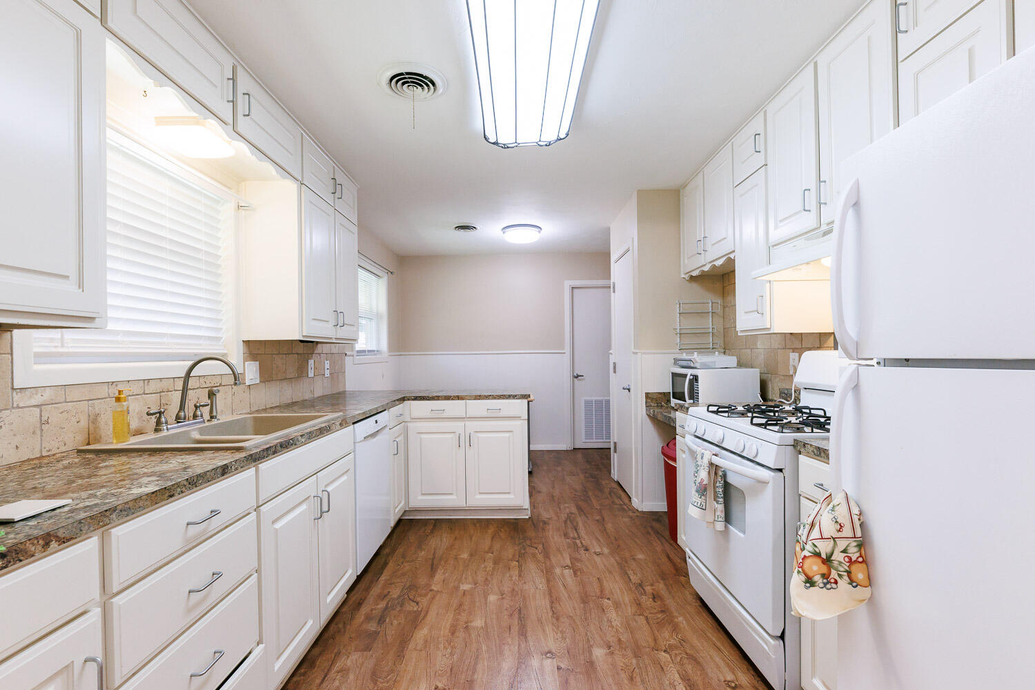3816 53rd Street Lubbock, TX 79413 - Photo 12 of 59 a kitchen with a sink stove and refrigerator