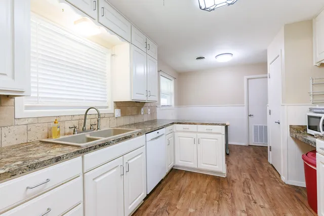a white refrigerator freezer sitting inside of a kitchen