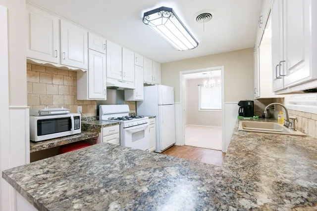 a kitchen with a sink window and cabinets