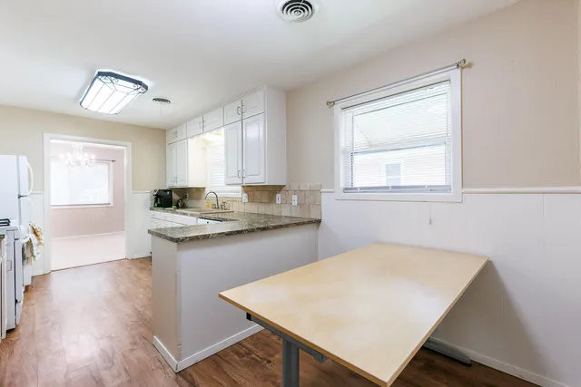 a living room with furniture and a gym machine
