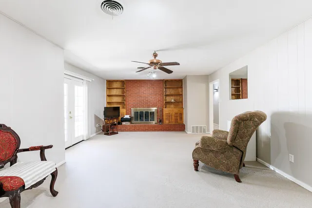 a view of an empty room with a ceiling fan