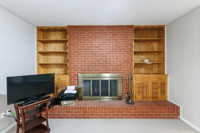 an empty room with fan and windows