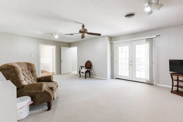 an empty room with a ceiling fan and a window