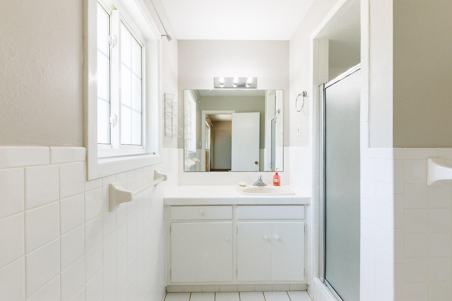 3816 53rd Street Lubbock, TX 79413 - Photo 30 of 59 a bathroom with a sink and a mirror