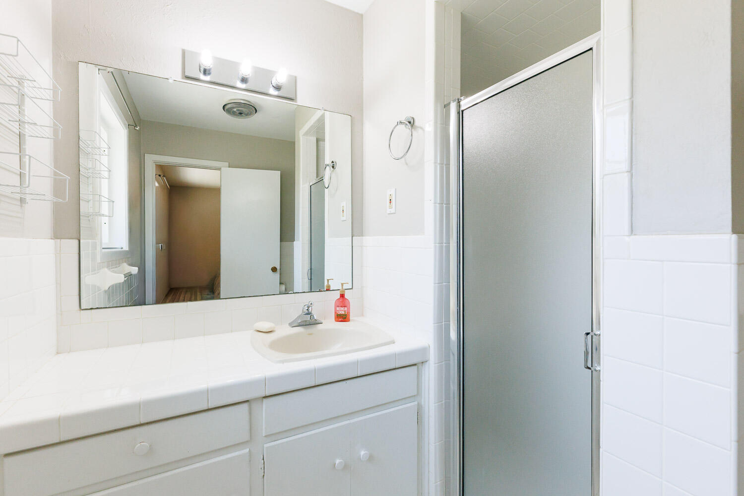 3816 53rd Street Lubbock, TX 79413 - Photo 31 of 59 a bathroom with a sink and a mirror
