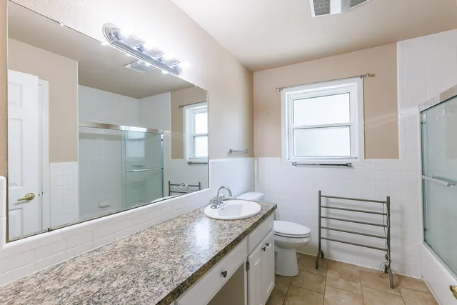 an empty room with closet and windows