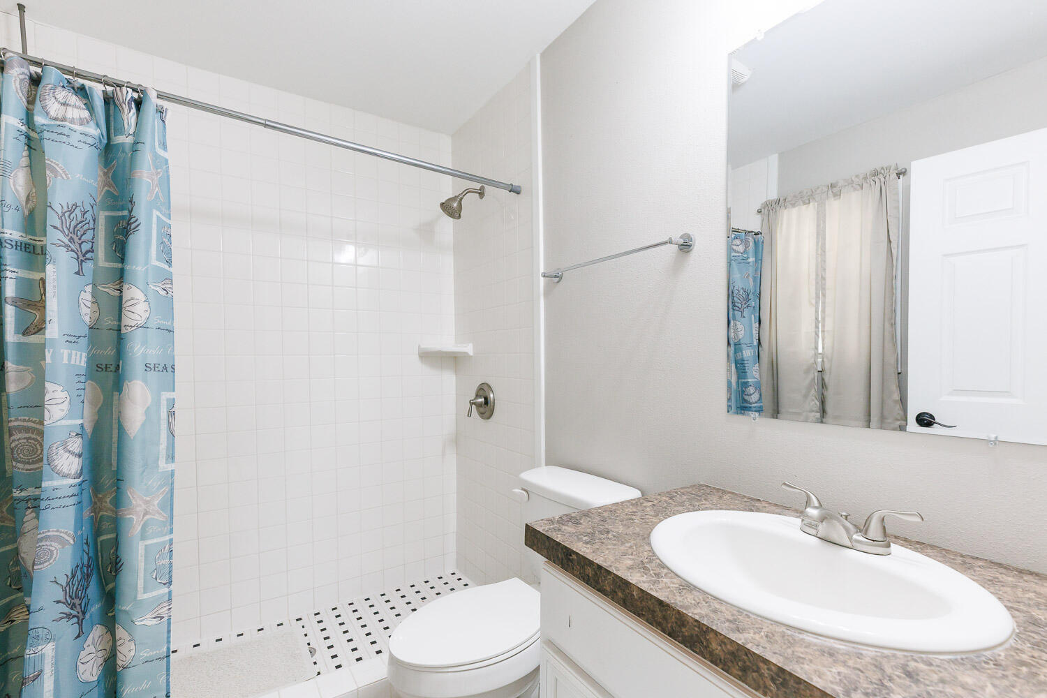 3816 53rd Street Lubbock, TX 79413 - Photo 41 of 59 a bathroom with a granite countertop sink a toilet a mirror and shower