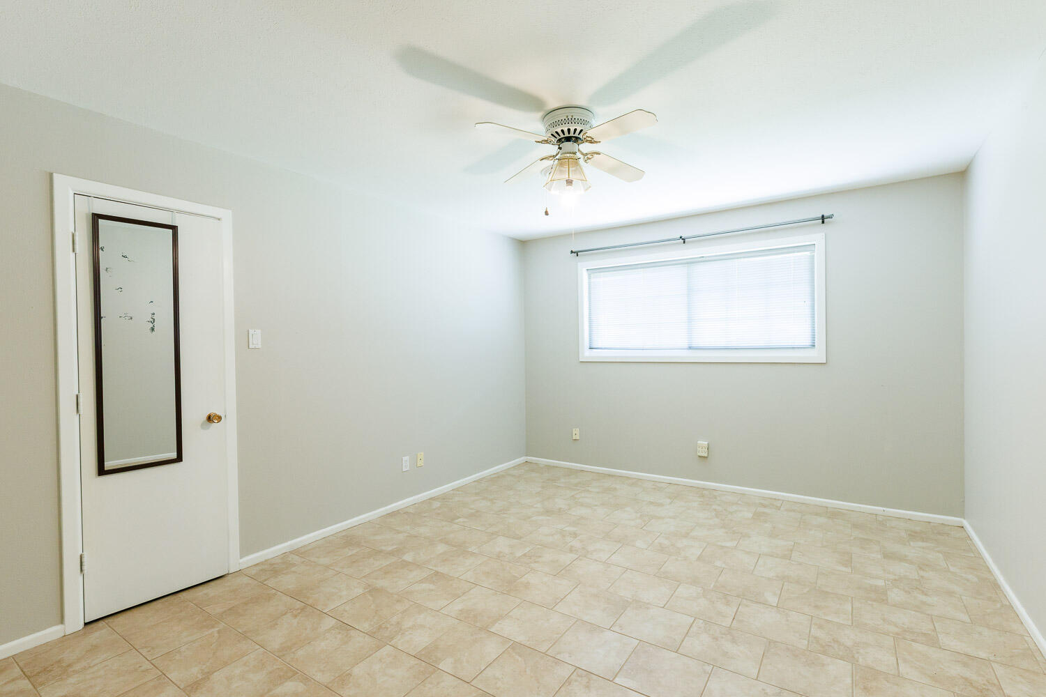 3816 53rd Street Lubbock, TX 79413 - Photo 44 of 59 an empty room with a chandelier fan and windows
